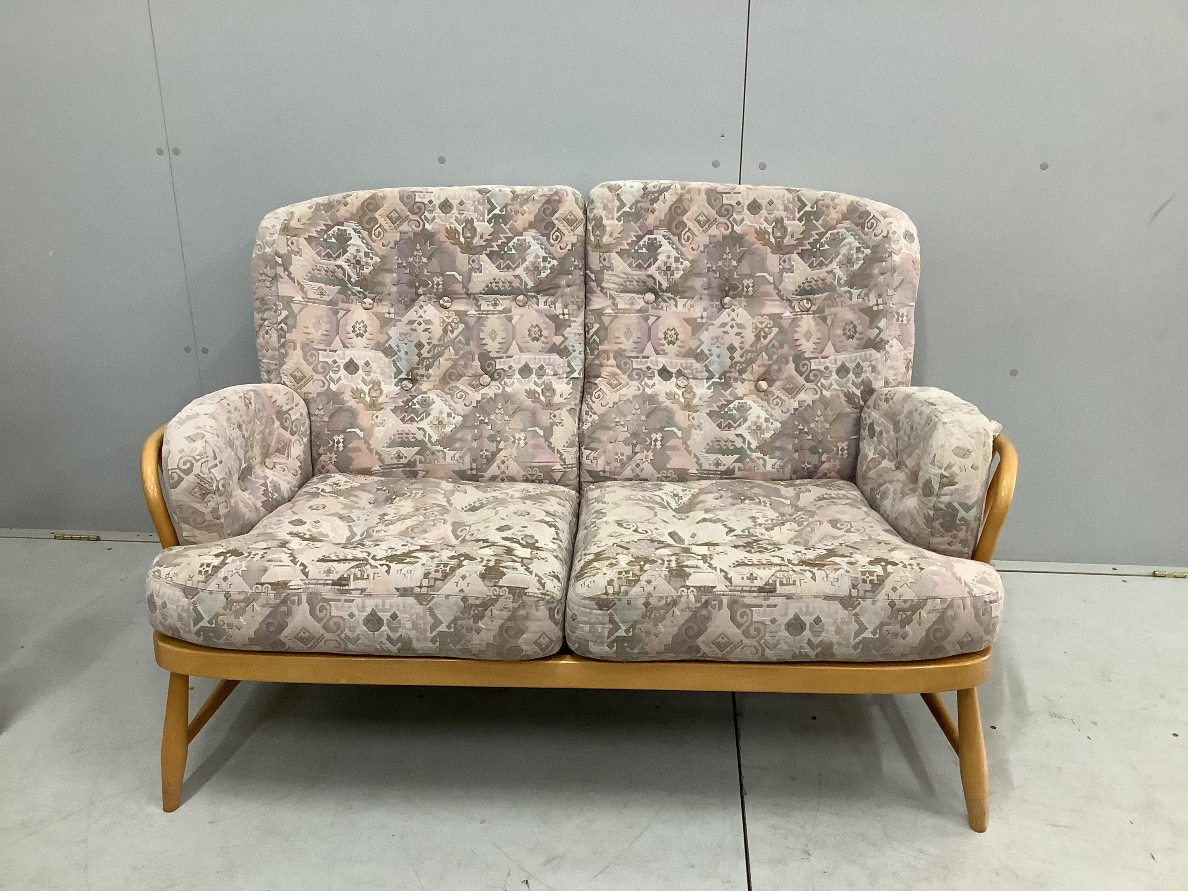 A pair of Ercol beech settees, width 140cm, depth 80cm, height 82cm